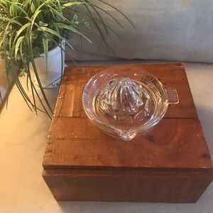 Retro glass juicer with handle and spout.